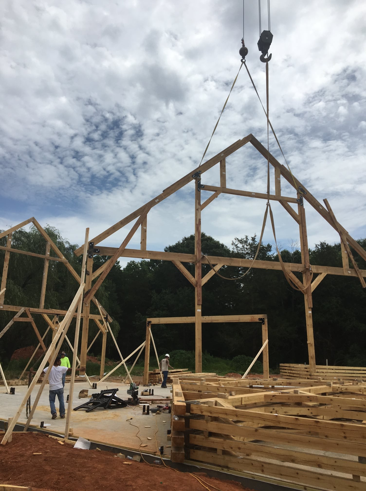 Timber frame being raised by crane, from the PM Services 97 company profile